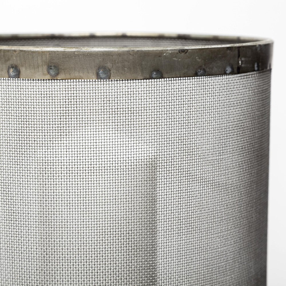 Close-up of a metal wire mesh cylinder with riveted edges.
