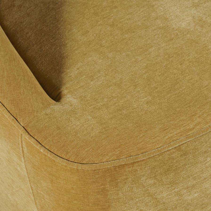 Close-up of a textured, golden brown fabric on a chair or sofa.