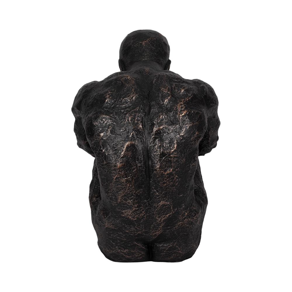 Bronze textured sculpture of a seated figure's back.
