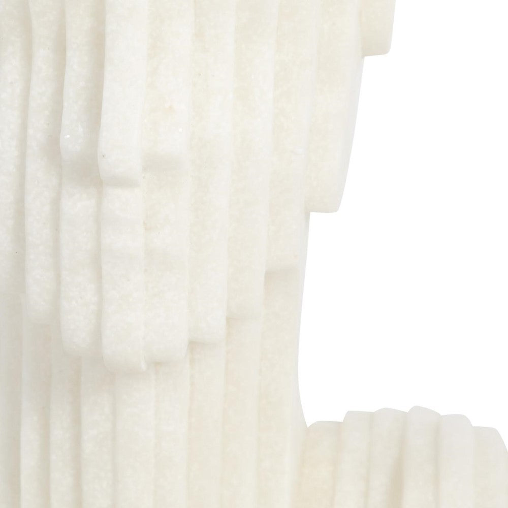 Close-up of stacked, textured white strips against a plain background.