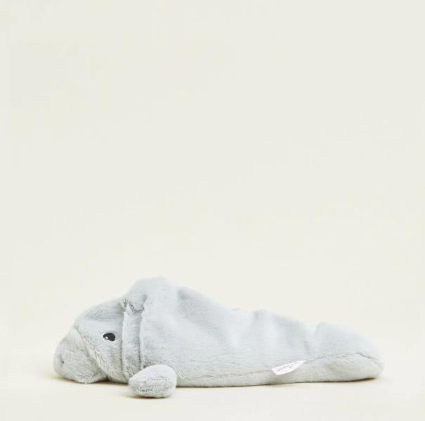 Gray plush walrus toy on a light beige background.