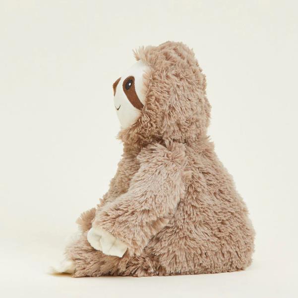 Side view of a fluffy sloth plush toy.