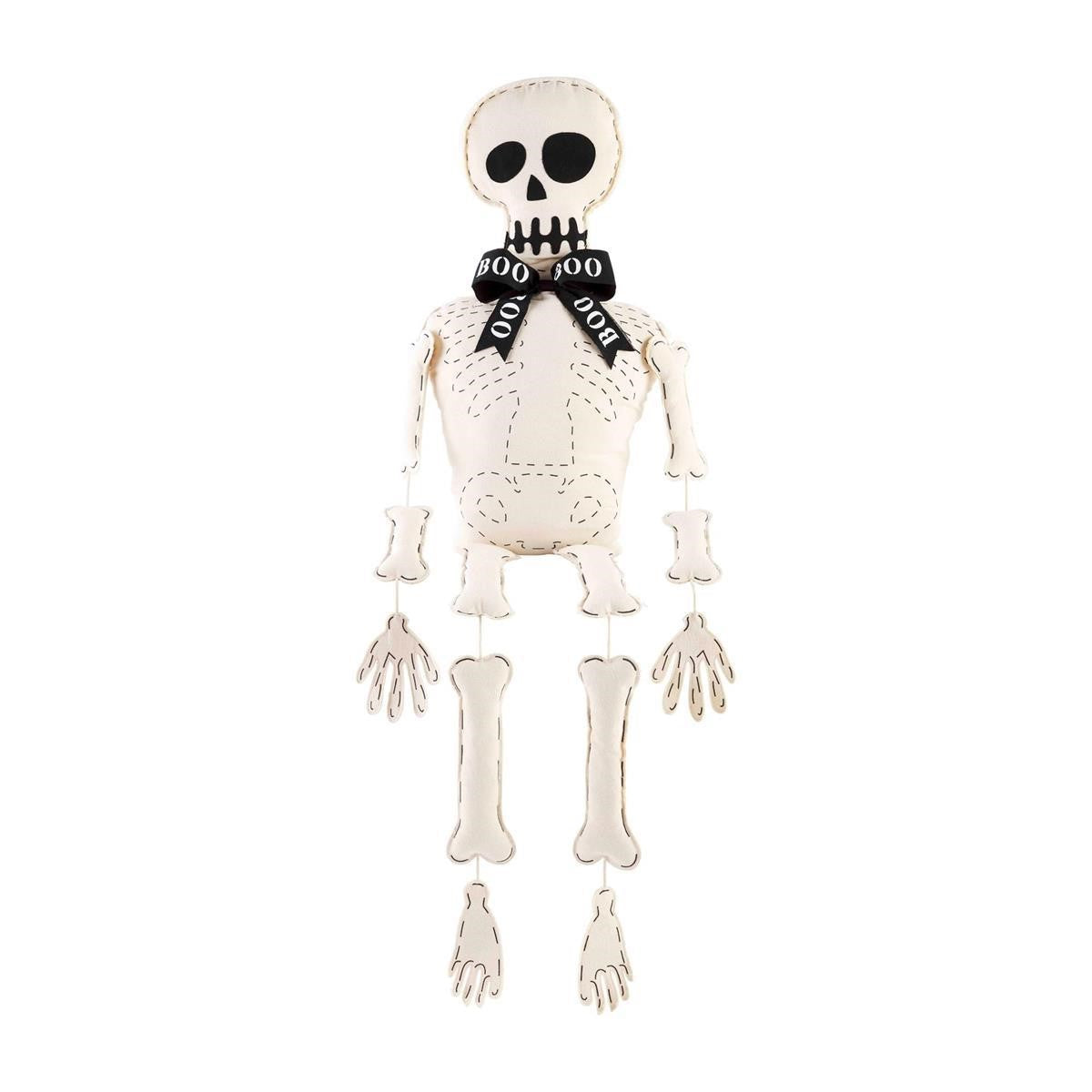Skeleton plush with "BOO" bowtie on white background.