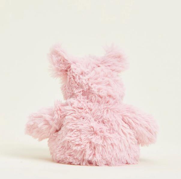 Fluffy pink teddy bear viewed from behind.