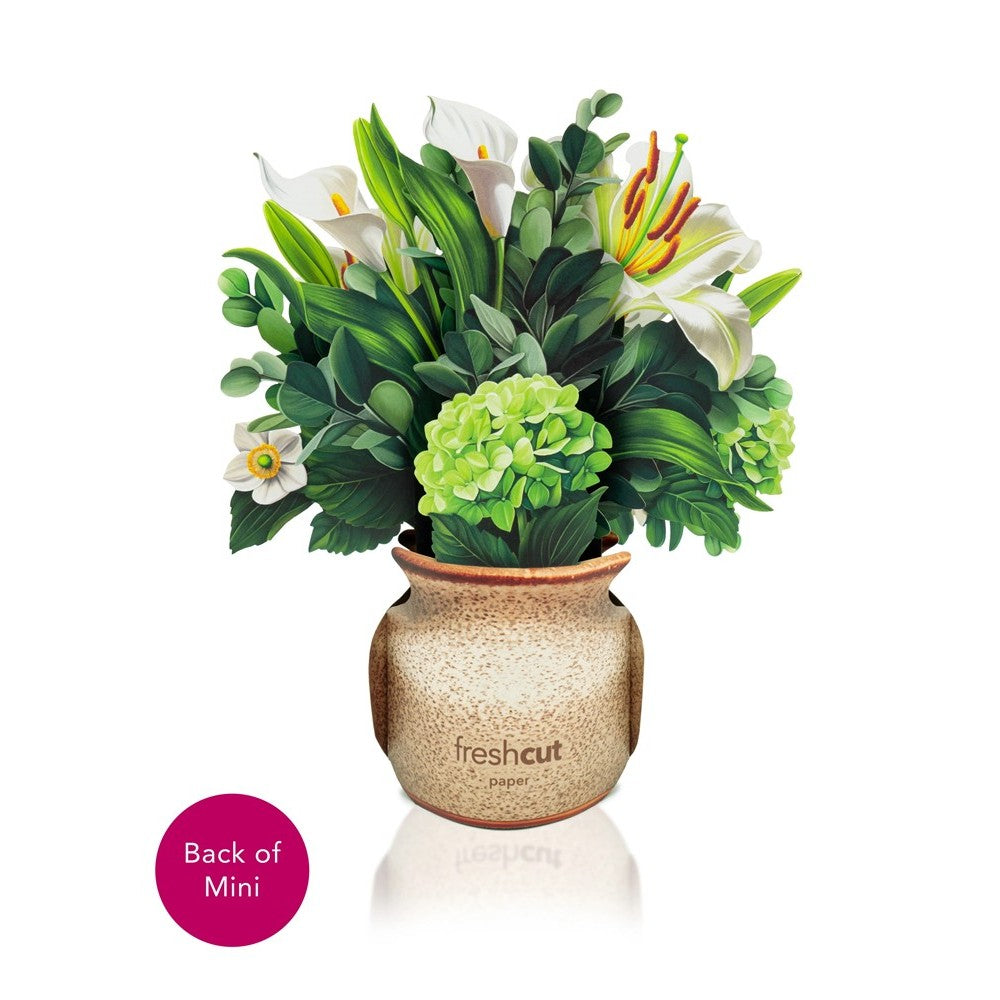 Paper bouquet in a speckled vase with assorted green and white flowers.