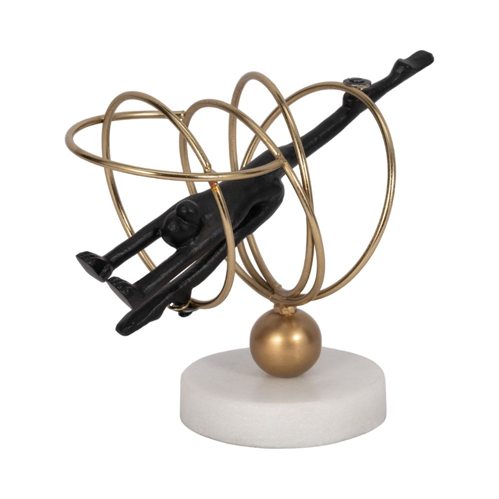Abstract sculpture: figure in golden rings on a stand.