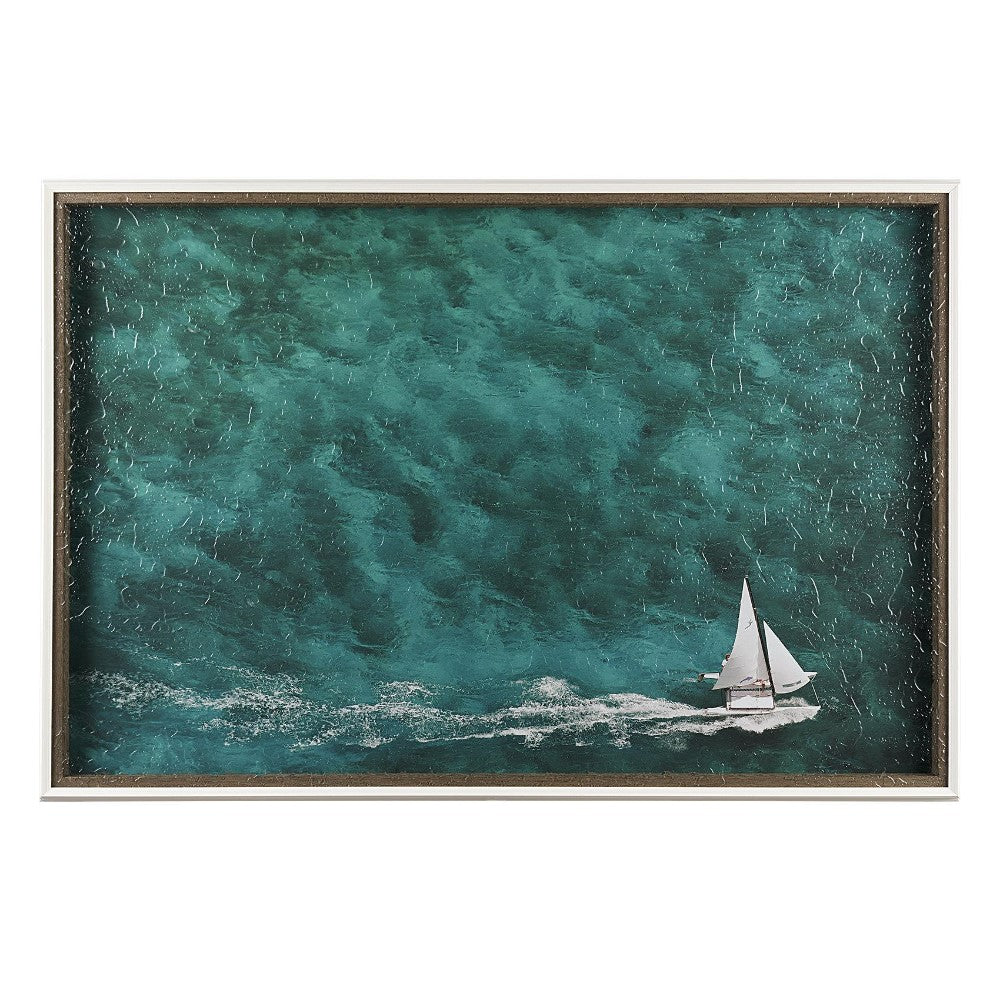 Sailboat gliding through deep teal waters.