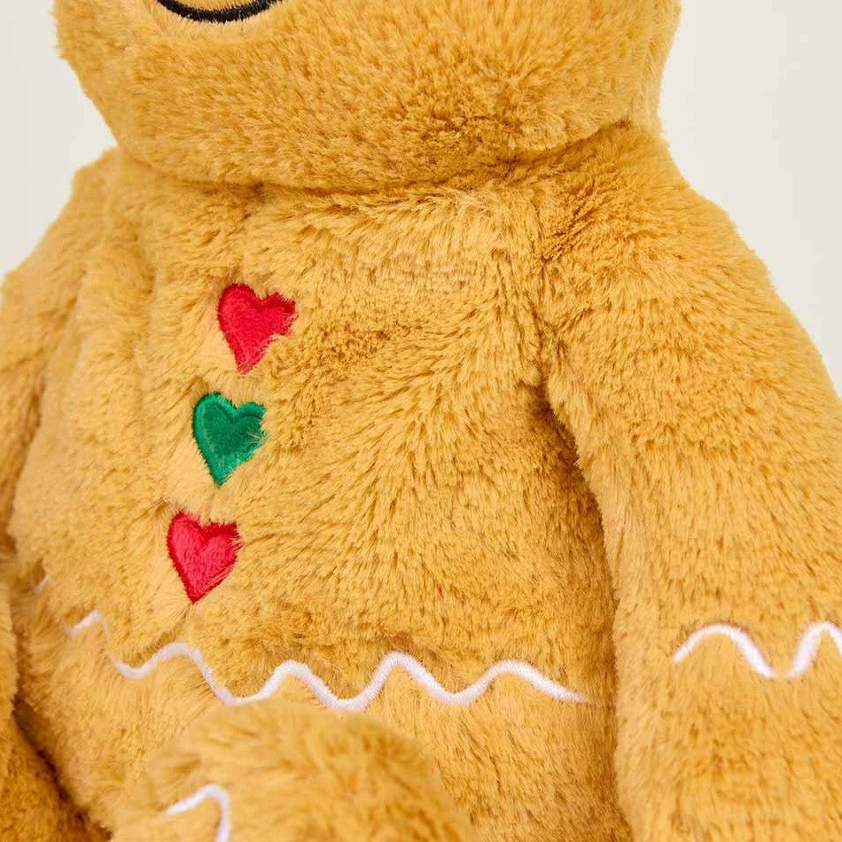 Fuzzy teddy bear with colorful heart-shaped buttons.
