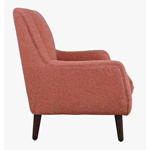 Side view of a red upholstered armchair with wooden legs.