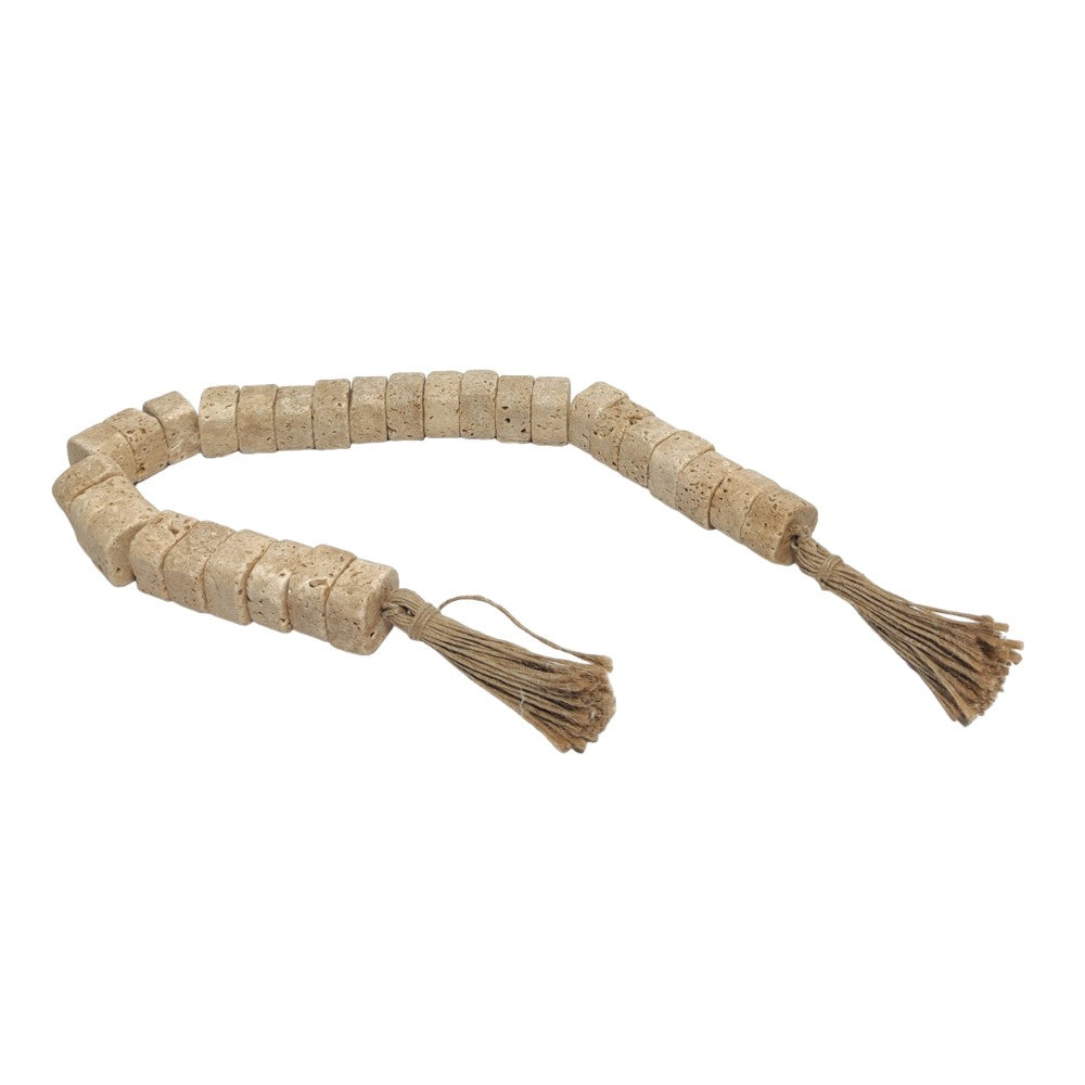 Beige stone prayer beads with tassels linked by string.
