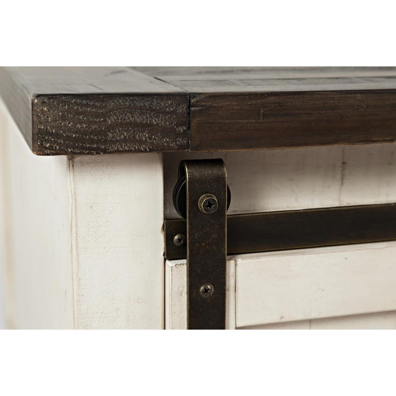 Rustic furniture corner with metal hinge detail.