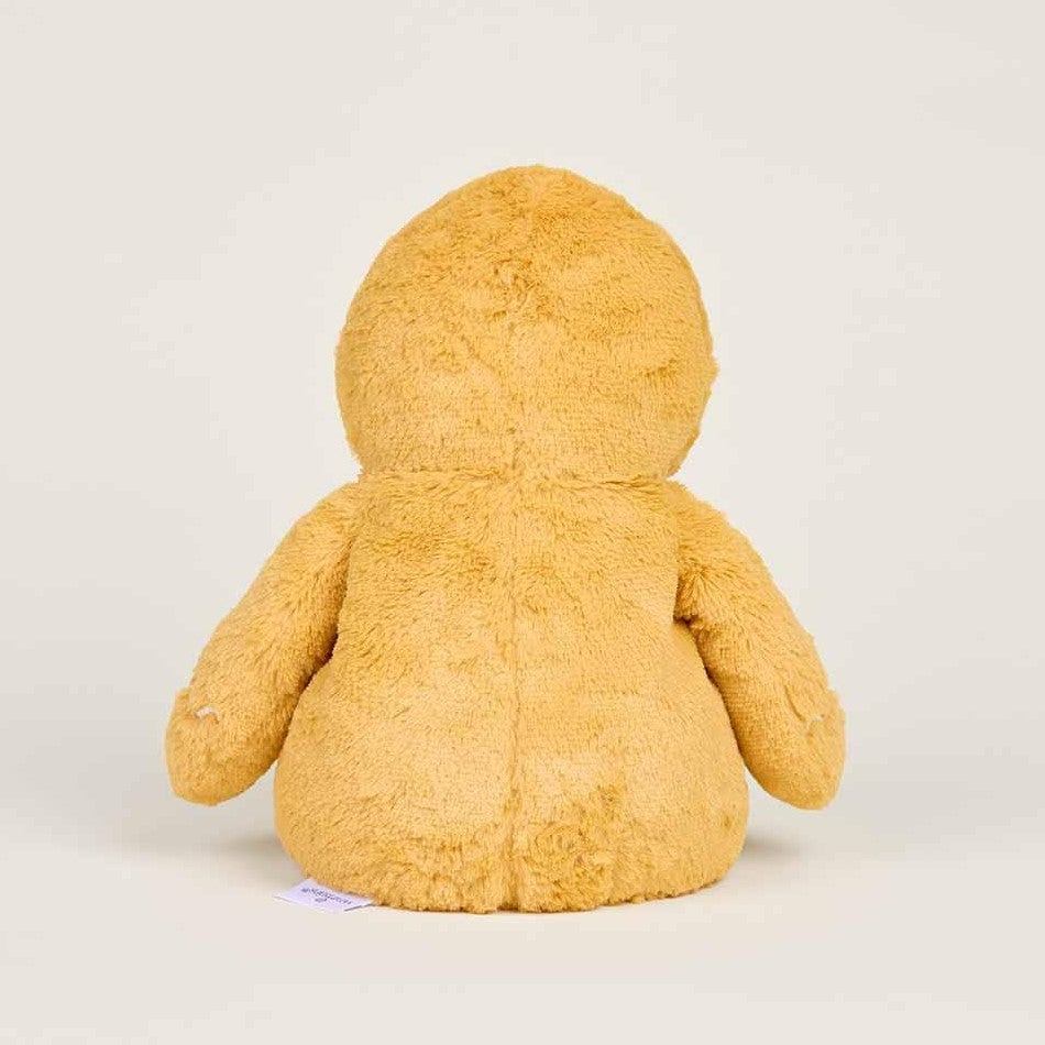 Brown teddy bear from behind on light background.