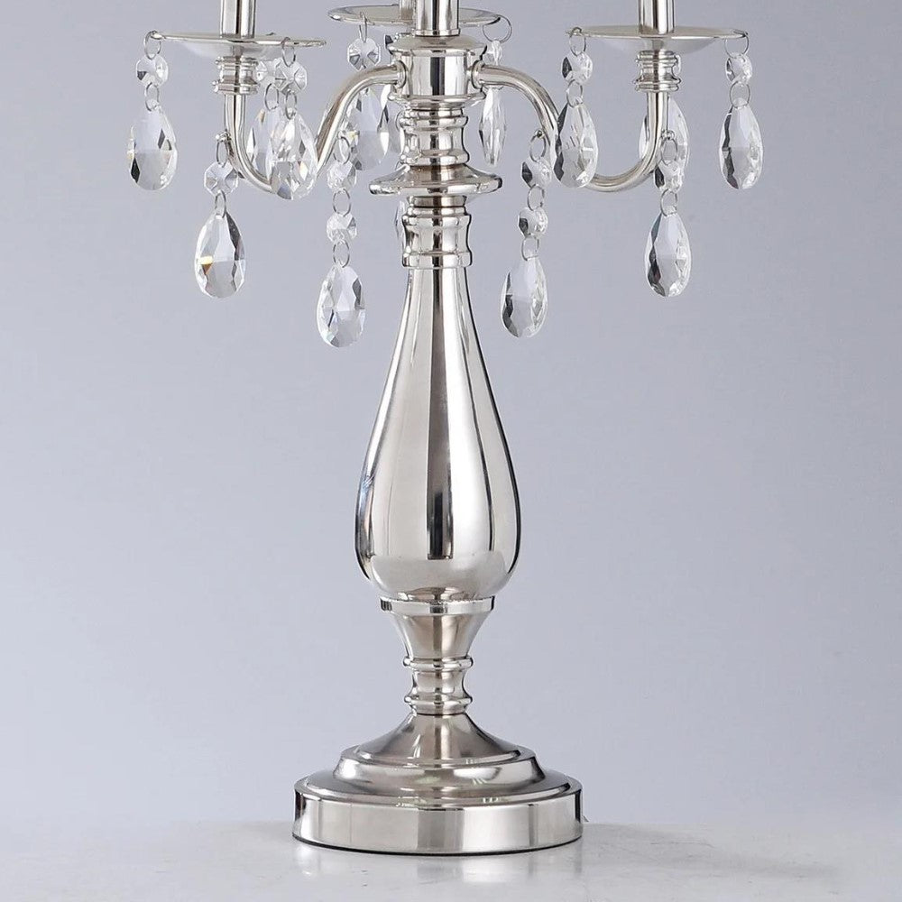 Silver candelabra with crystal accents, elegant and shiny.