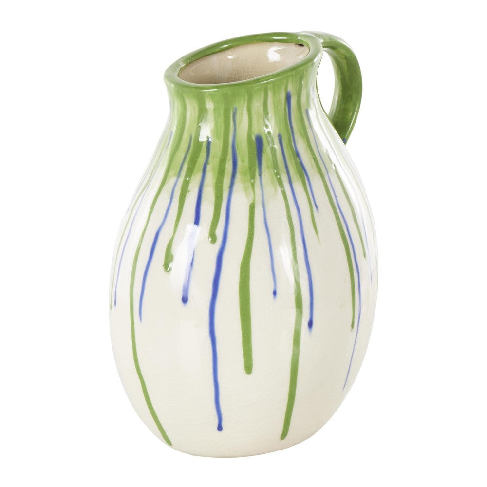 Ceramic jug with green and blue drips on a white background.
