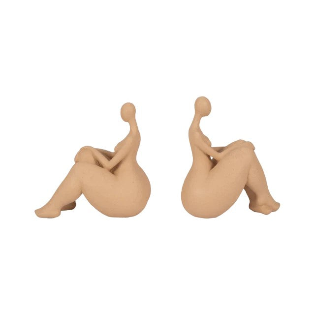 Two minimalist figures sitting with legs bent and crossed.