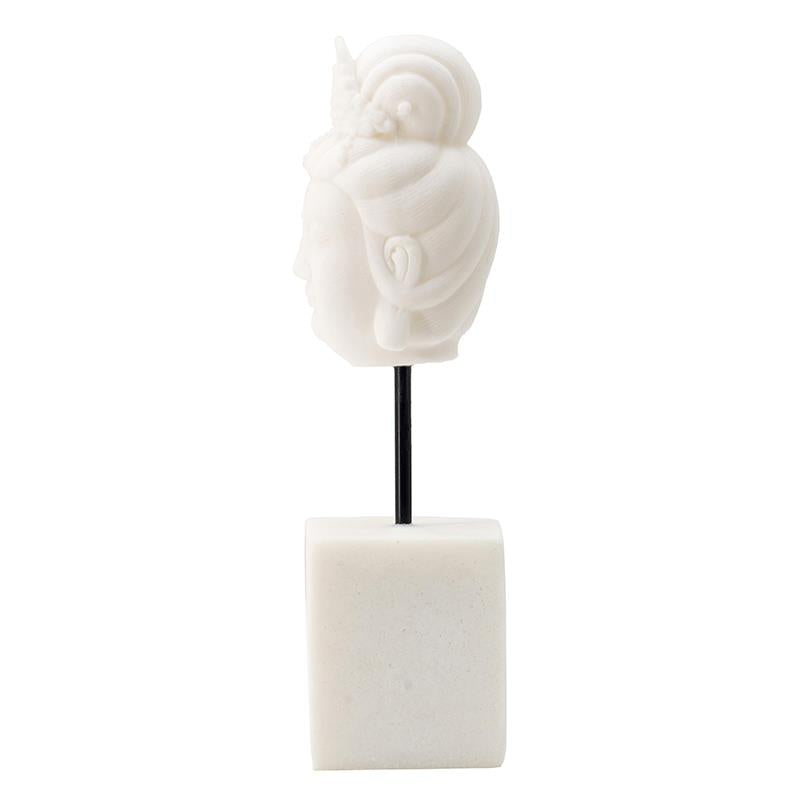 White ornate head sculpture on a black rod with marble base.