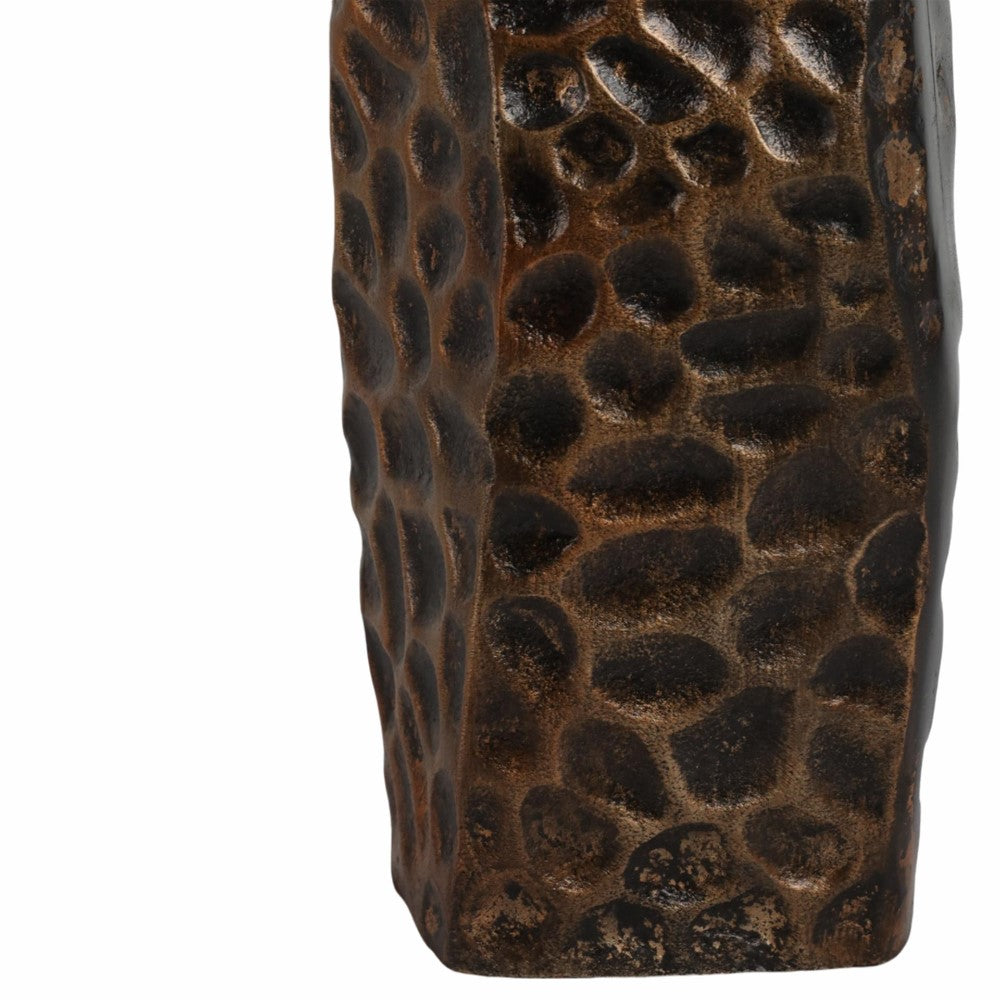 Textured brown, stone-like surface with uneven, rounded shapes.