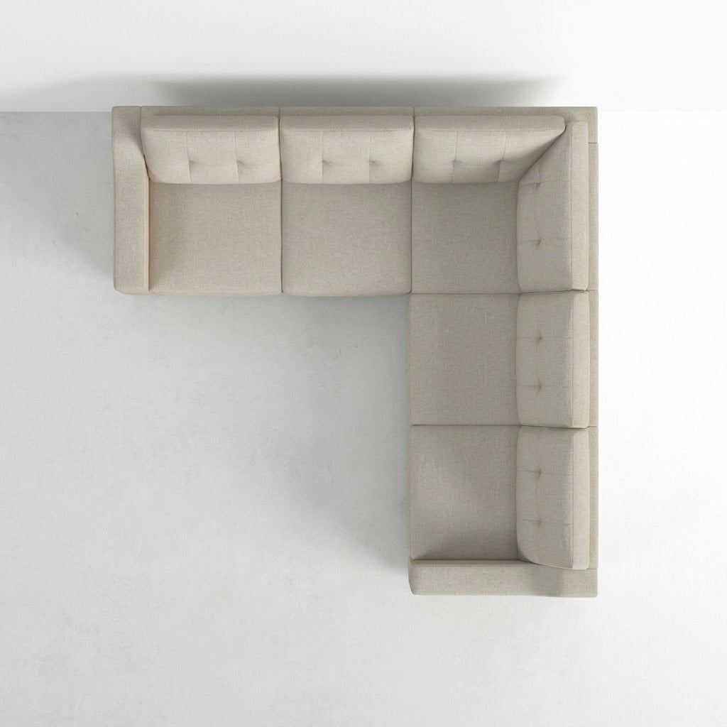 Top view of an L-shaped beige sofa on a light background.