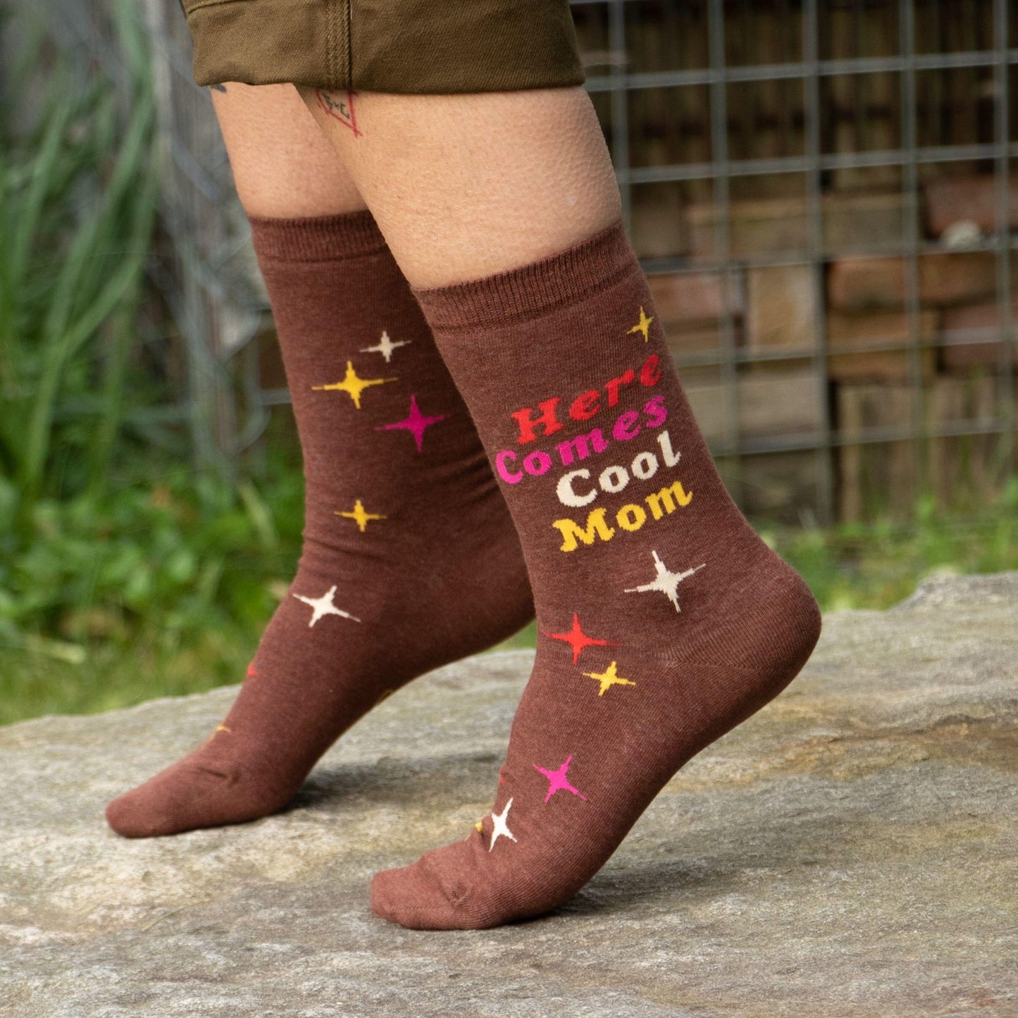 Brown socks with "Here Comes Cool Mom" text and star designs.