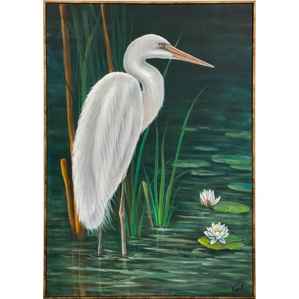 White heron in a pond with lily pads and reeds.