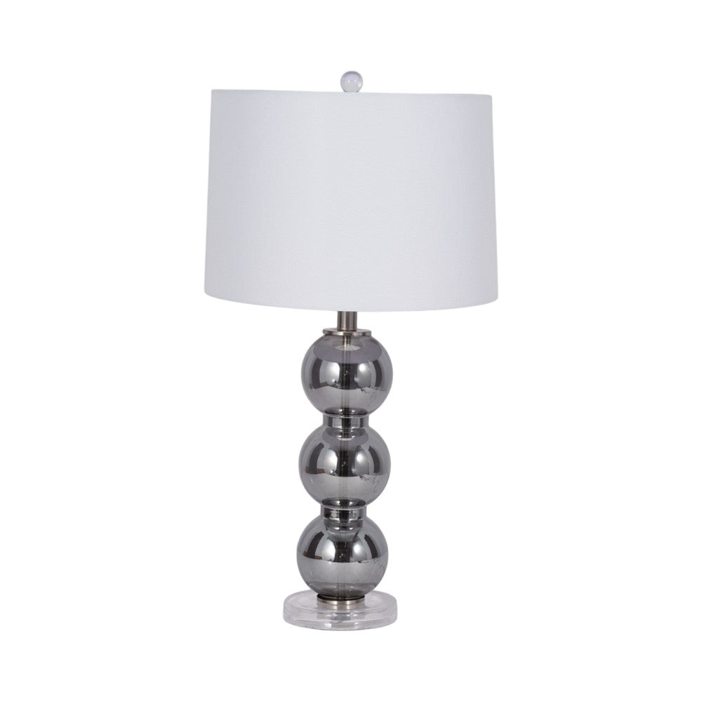 Modern lamp with a white shade and stacked metallic spheres as base.