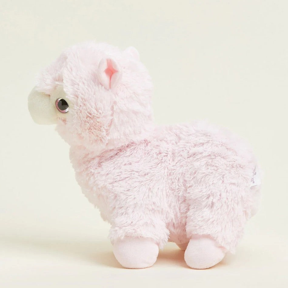 Pink fluffy llama plush toy on a light background.