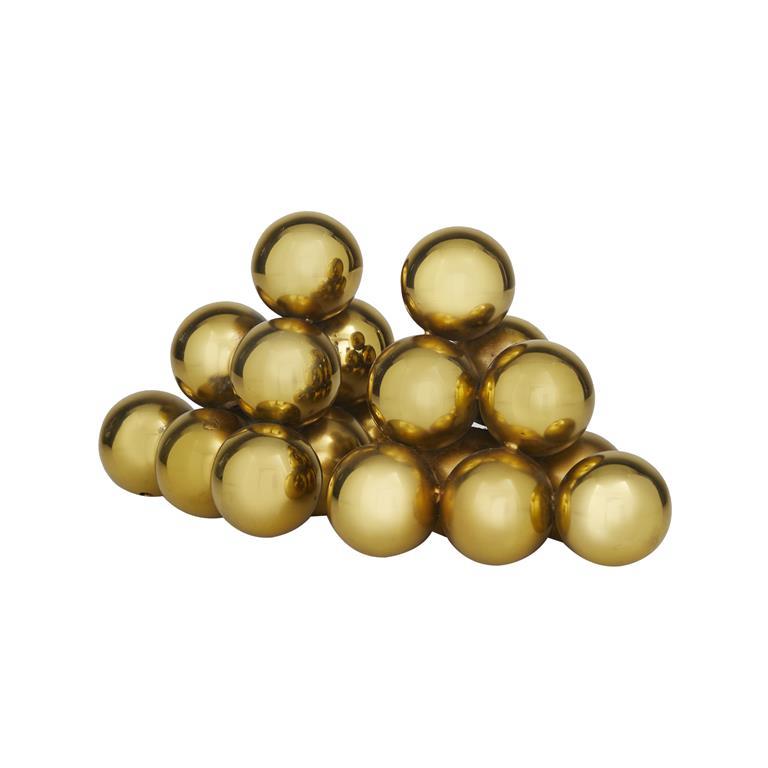 Gold reflective spheres stacked in a pyramid shape.