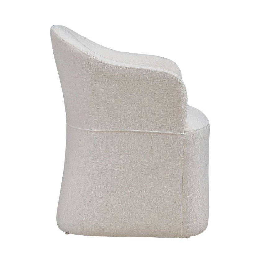 White, modern armchair viewed from the side.