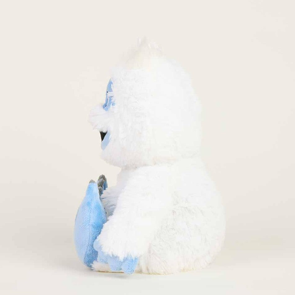 Fluffy white and blue yeti plush toy sitting sideways.