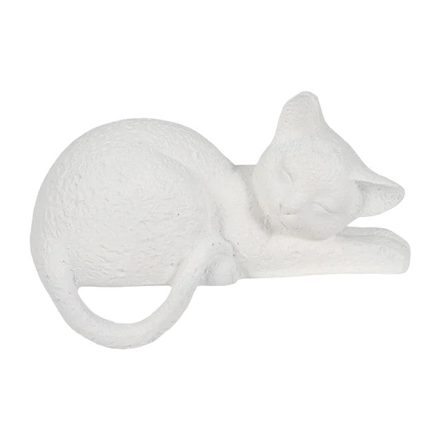 White cat statue sleeping, curled up compactly.