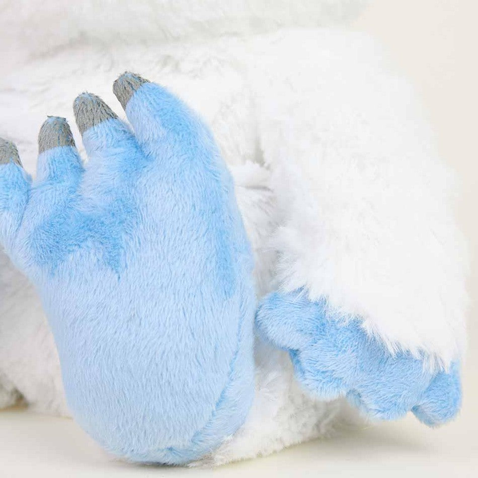 Close-up of a plush toy with blue paws and soft white fur.