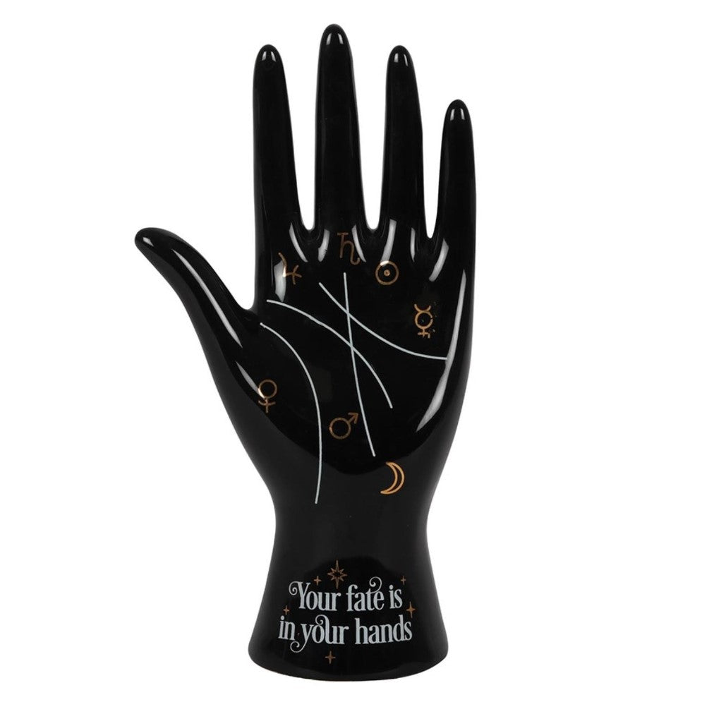 Black hand sculpture with astrology symbols and "Your fate is in your hands" text.