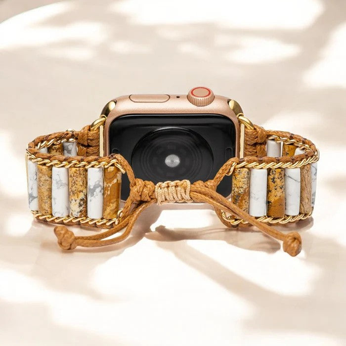 Smartwatch with a beaded, braided band on a light background.