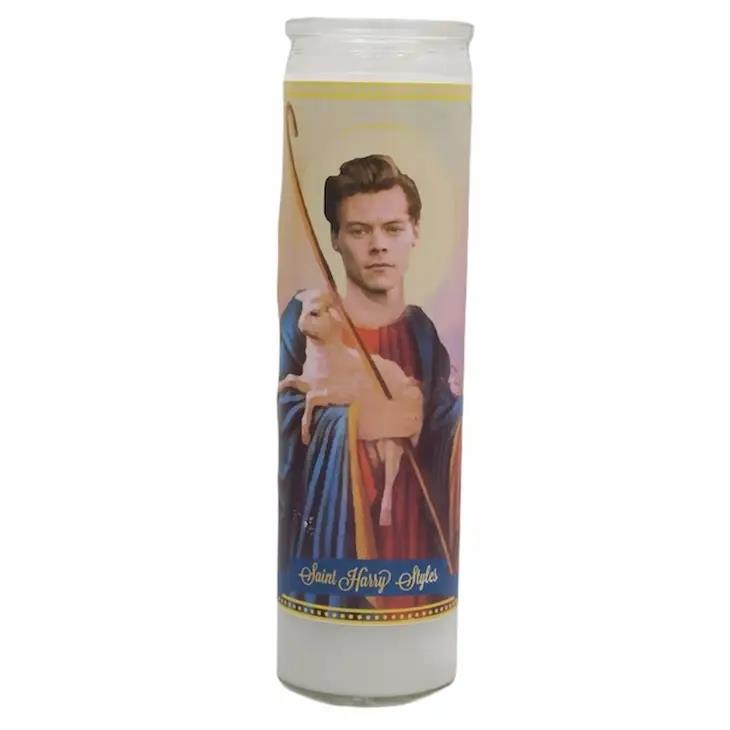 Decorative candle with a person's image and the text "Saint Harry Styles."