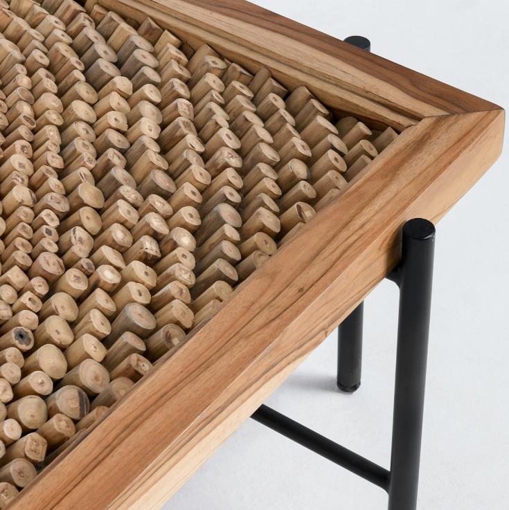 Wooden table with textured, geometric pattern surface.