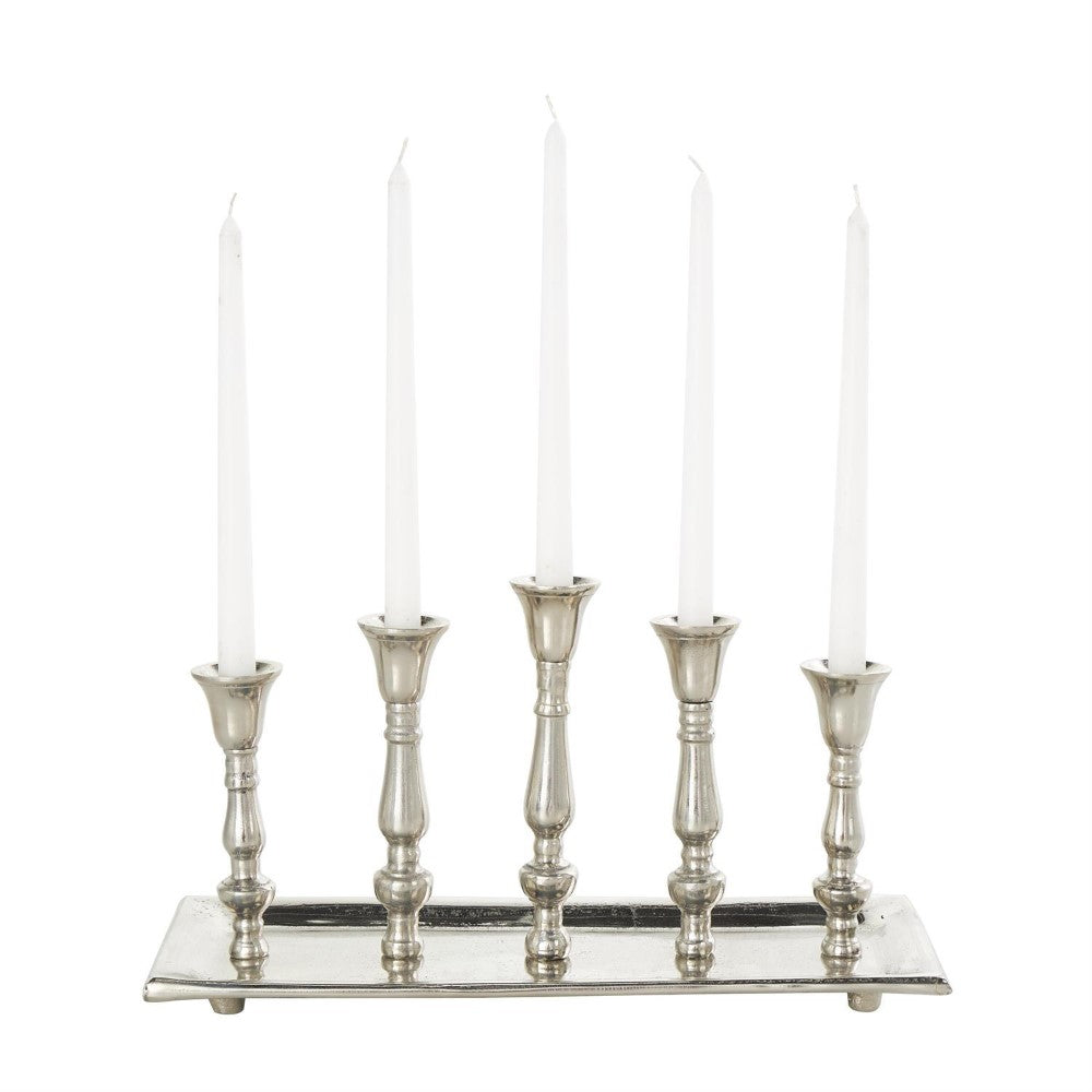 Five silver candle holders with white candles.