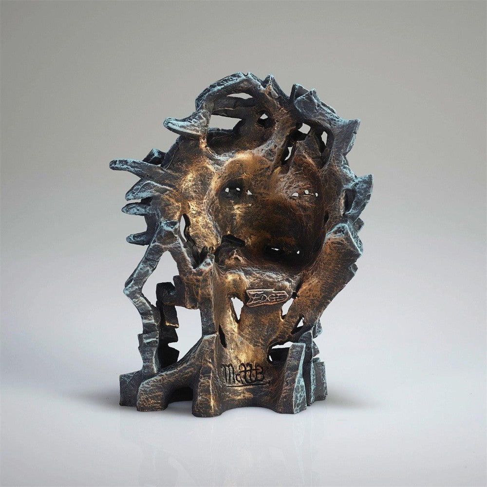 Abstract bronze sculpture with intricate, organic shapes and textures.