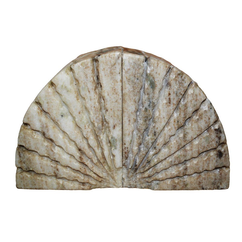 Marble sculpture resembling an open fan with a textured, weathered surface.