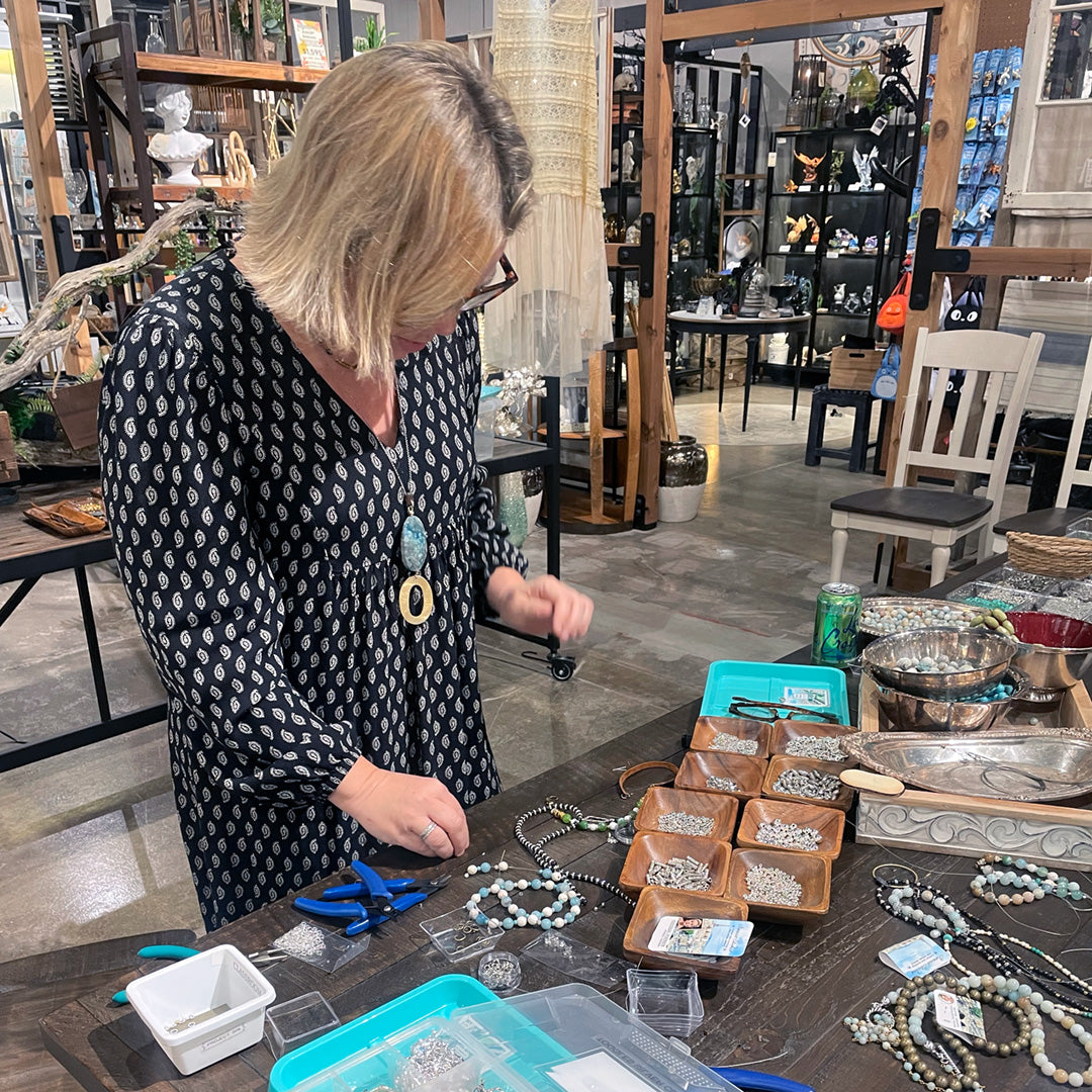 Jewelry workshop instructor selecting parts