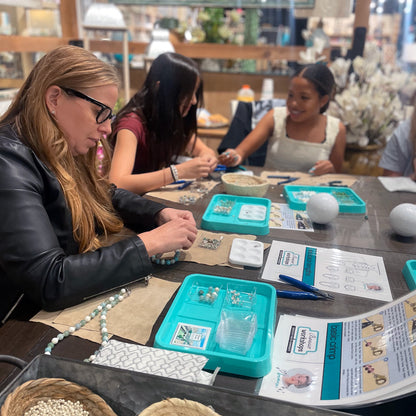 Jewelry workshop participants focusing on their work