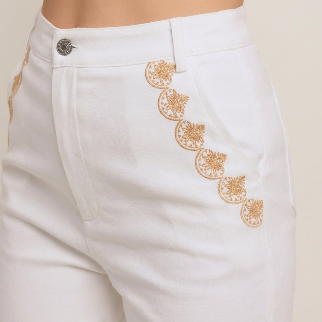 White pants with gold embroidery detail on the sides.