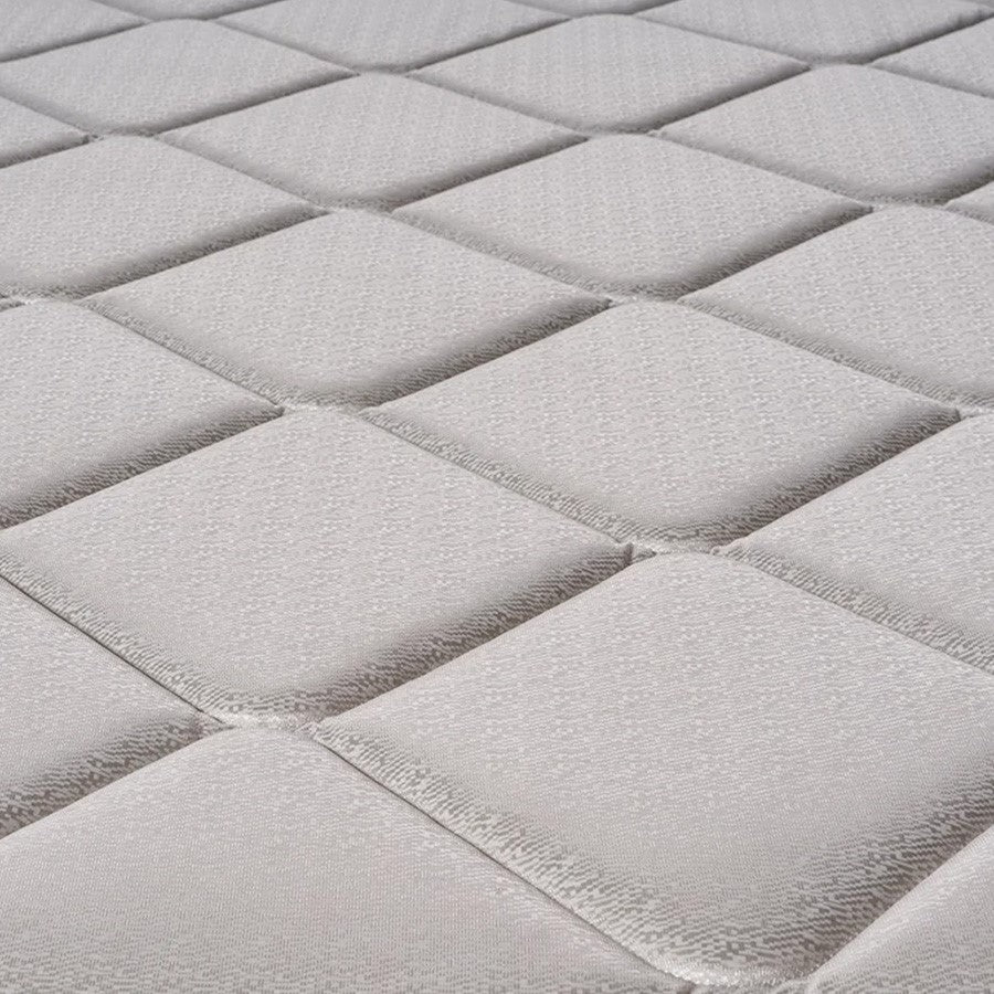 Close-up of quilted gray fabric with a textured pattern.