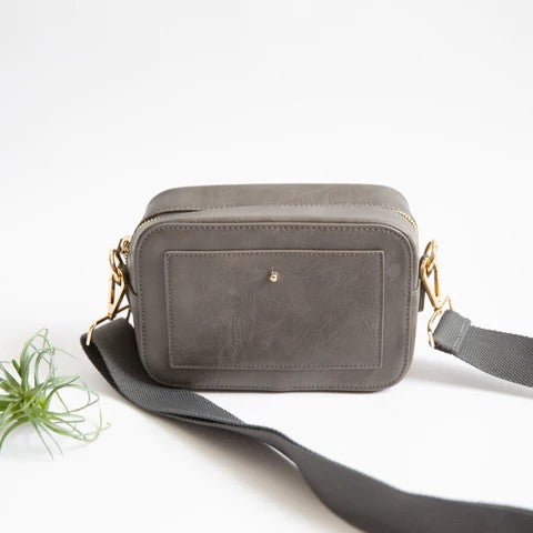 Gray crossbody bag with gold clasps and a thick strap, set against a white background.