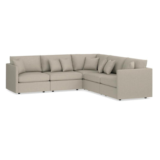 Beige L-shaped sectional sofa with cushions.