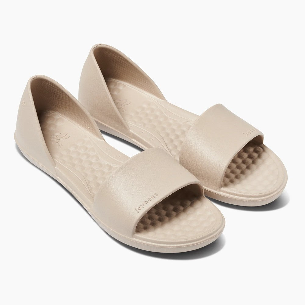 Beige slip-on sandals with textured insoles.