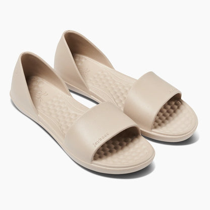 Beige slip-on sandals with textured insoles.