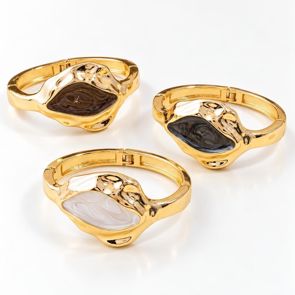 Three gold bracelets with multicolored stone designs.