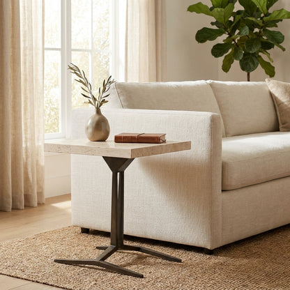 Minimalist living room with sofa, side table, and plant.