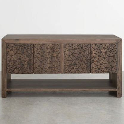 A wooden sideboard with geometric carved doors and an open lower shelf.