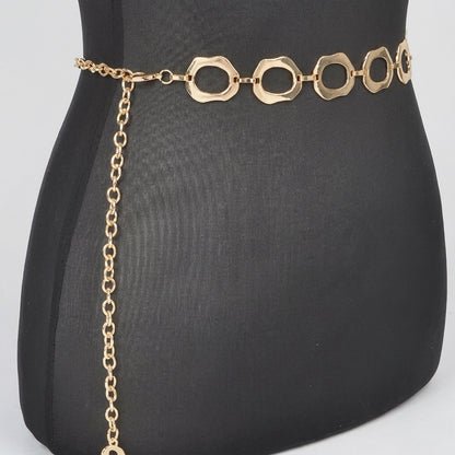 Gold chain belt with circular links on a black mannequin.